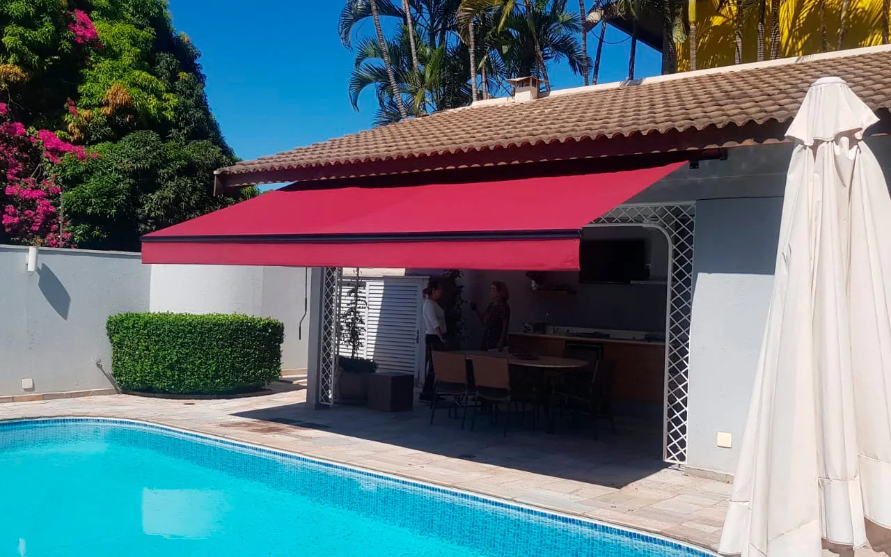 Toldo articulado sobre área de piscina, executado pela Miraflex