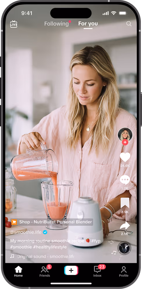 Woman pouring a pink smoothie from a blender jar into a glass container in a kitchen, shown on a TikTok video interface.