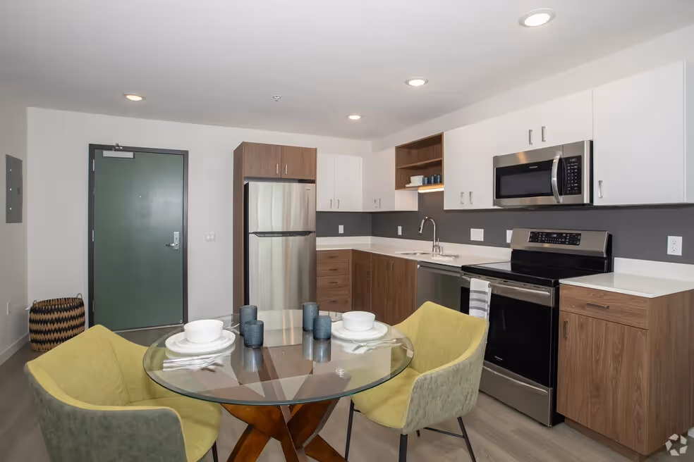 Kitchen with brown cabinets and dining table set