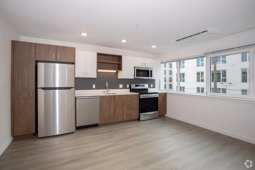 Kitchen with brown cabinets and stainless steel appliances