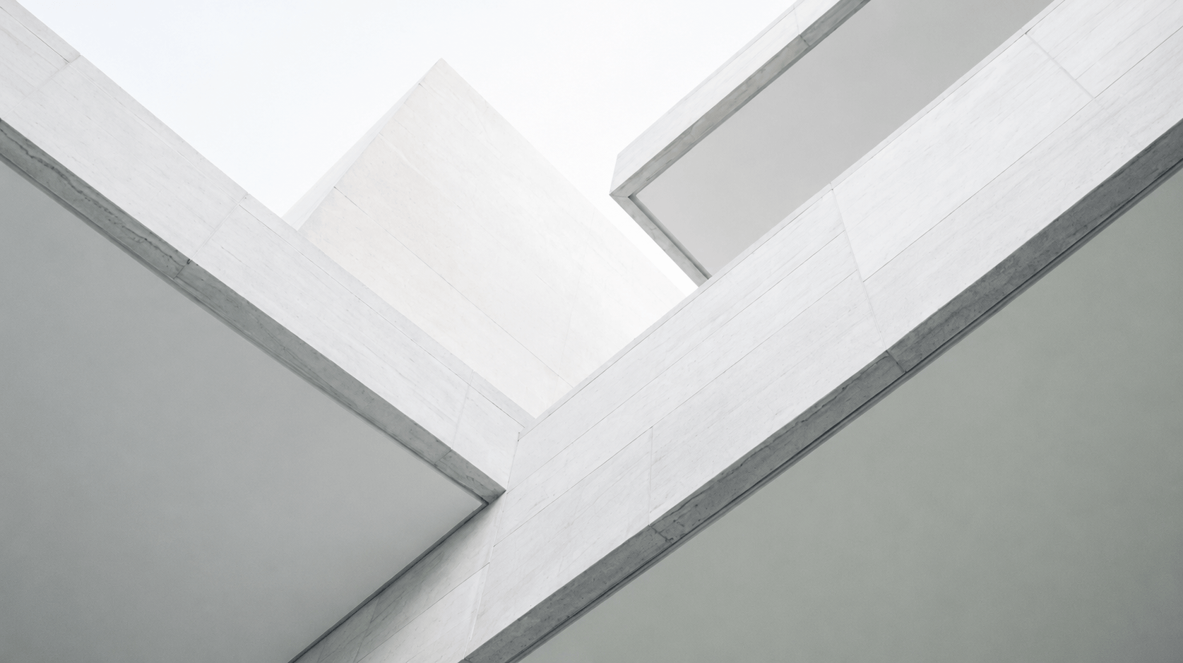 Close-up view of white concrete modern building architecture with sharp angles and clean lines.
