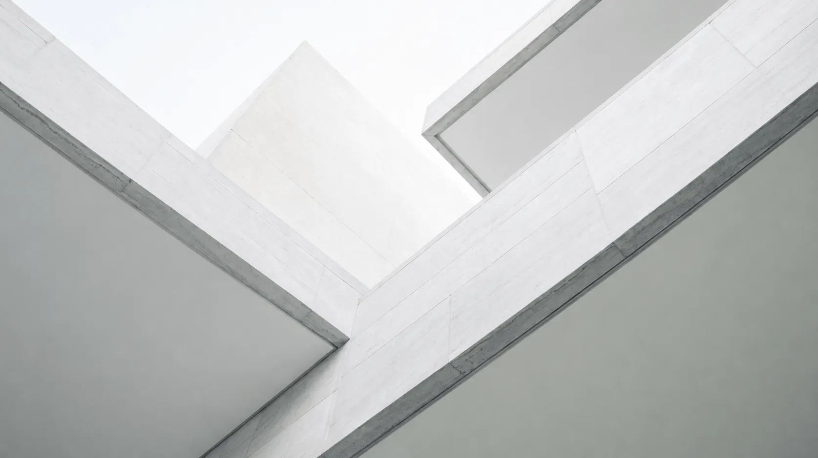Close-up view of white concrete modern building architecture with sharp angles and clean lines.