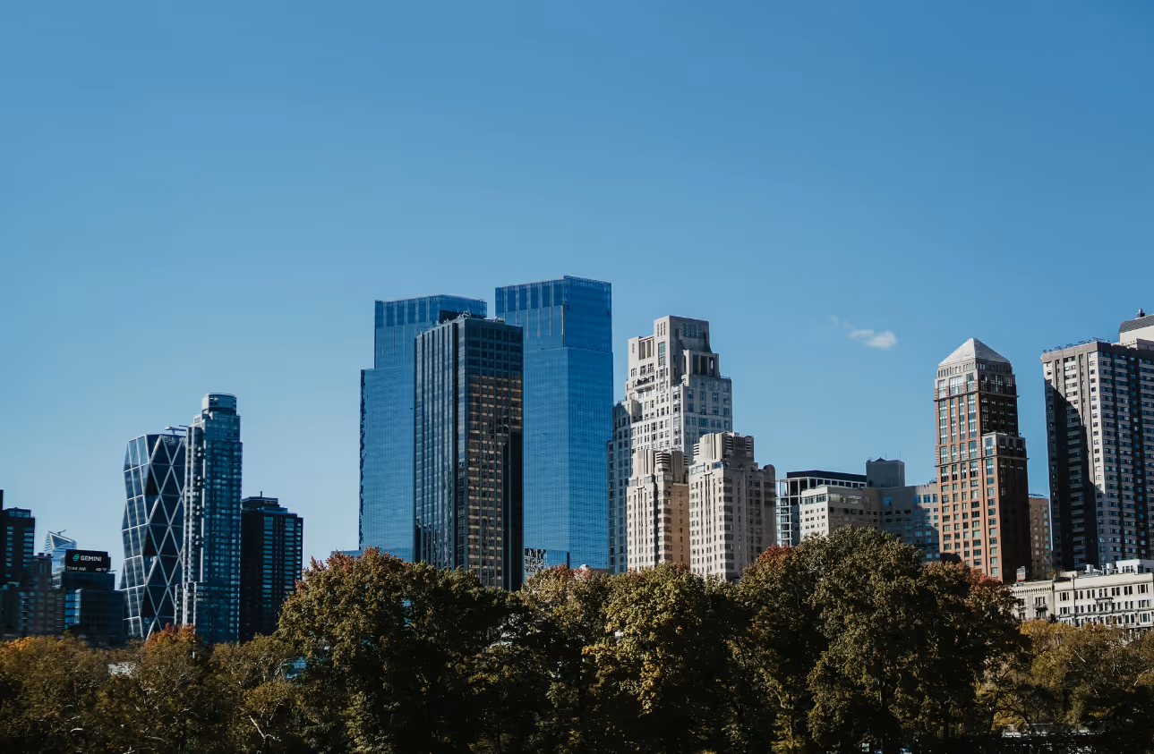 Buildings in an urban setting surrounded by greenery.