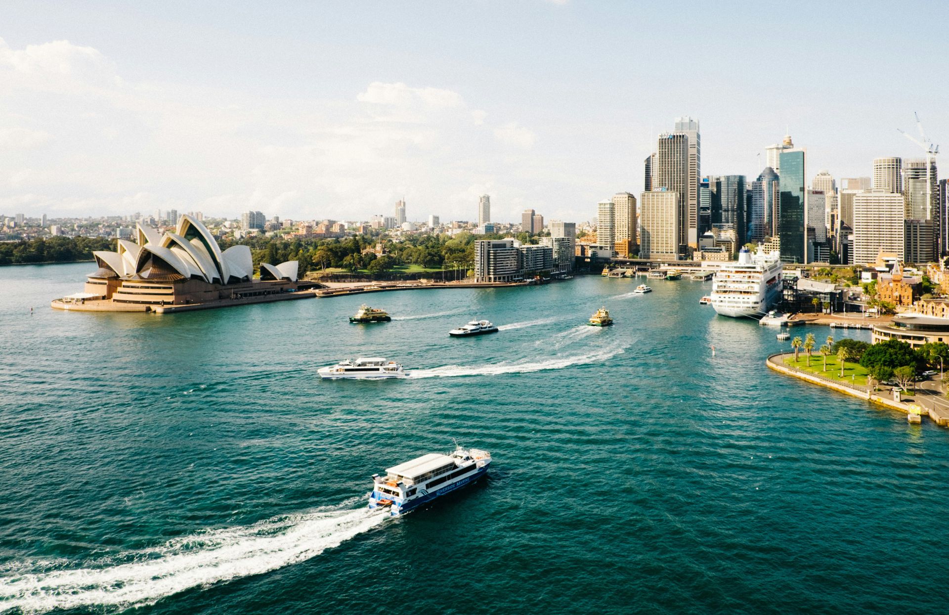 Sydney Opera House with Sydney's central business district skyline in the background.