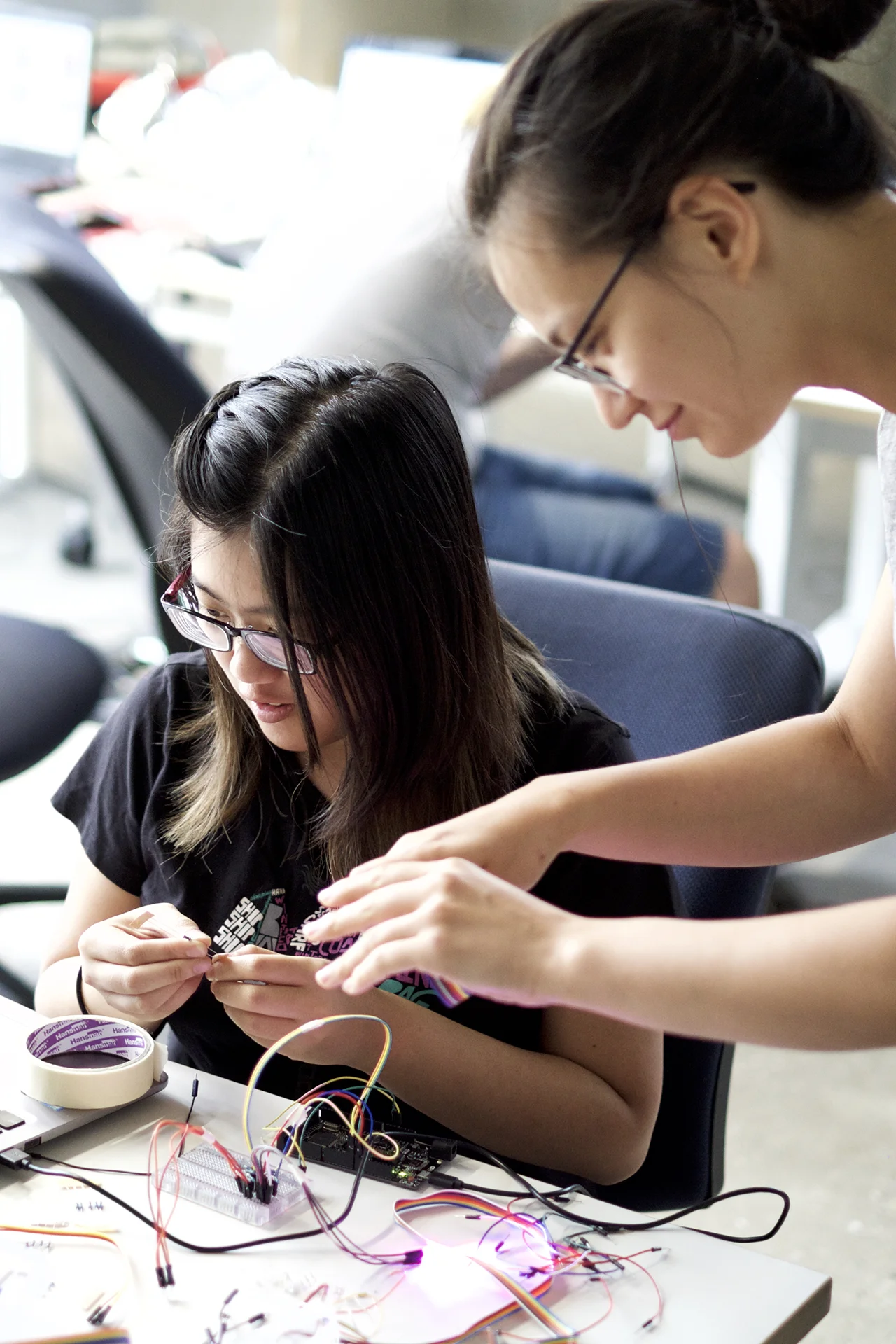 Two designers discussing cable management plans during installation development