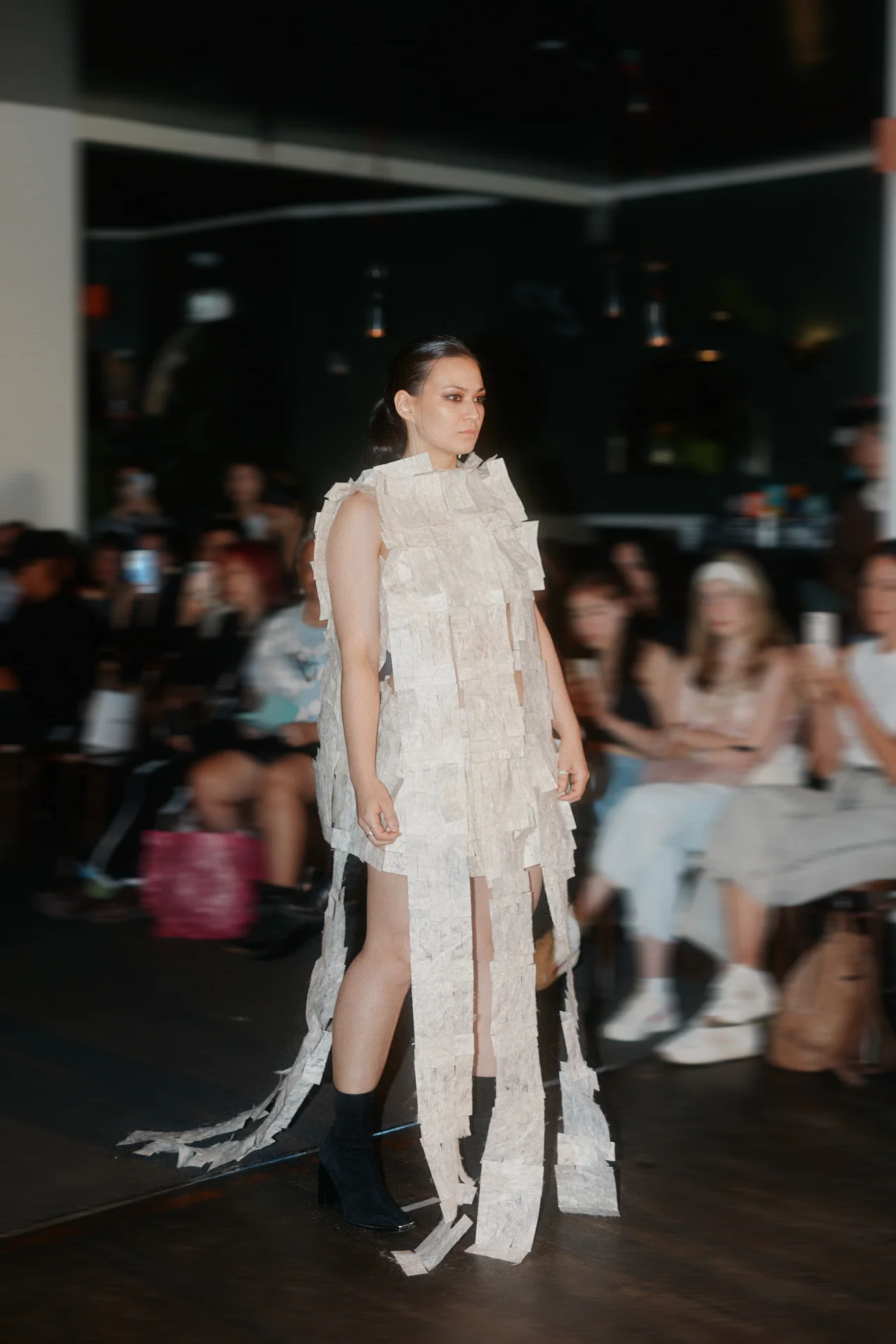 Model wearing silk paper experimental garment on runway