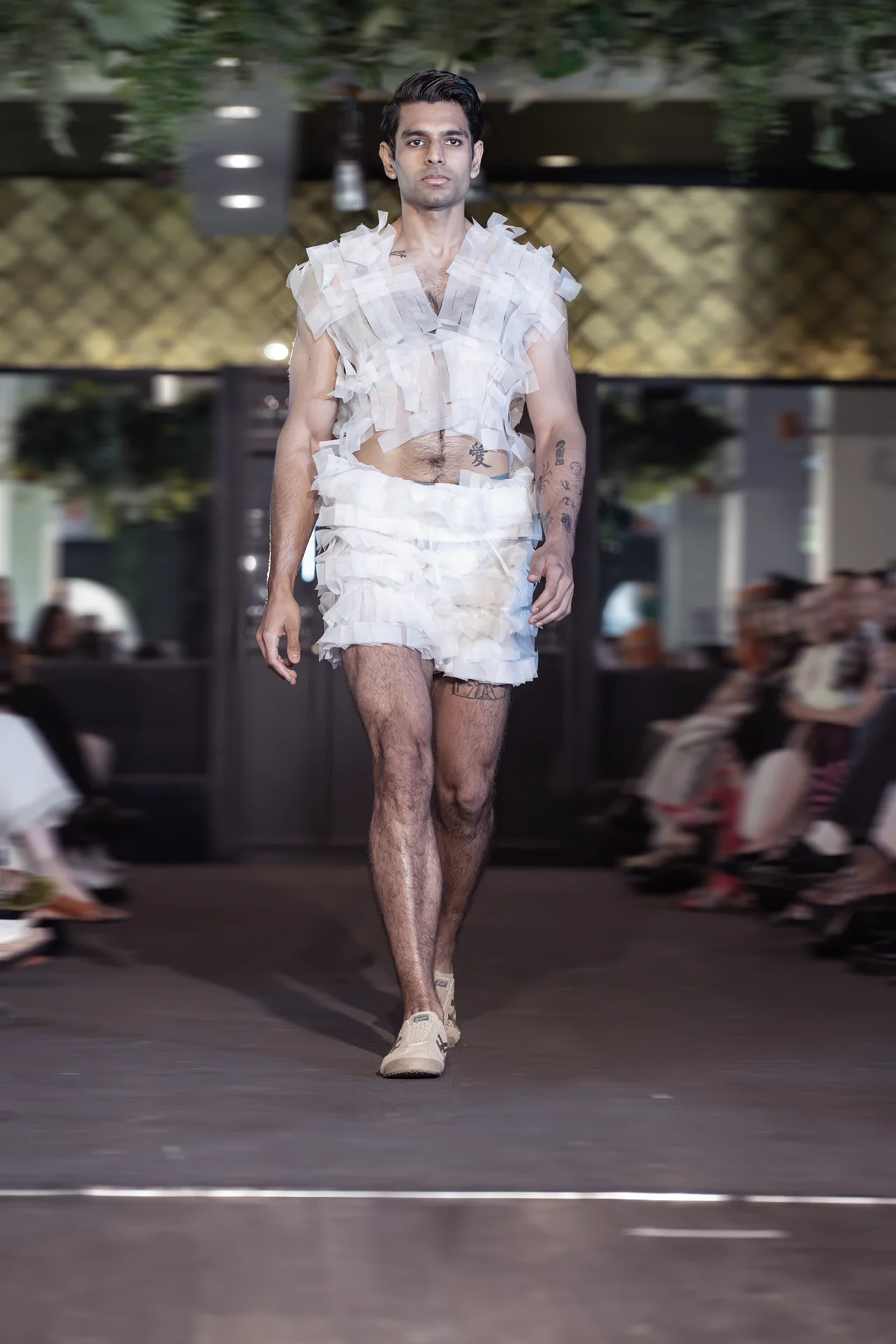 Male model walking runway in modular woven silk organza fashion design