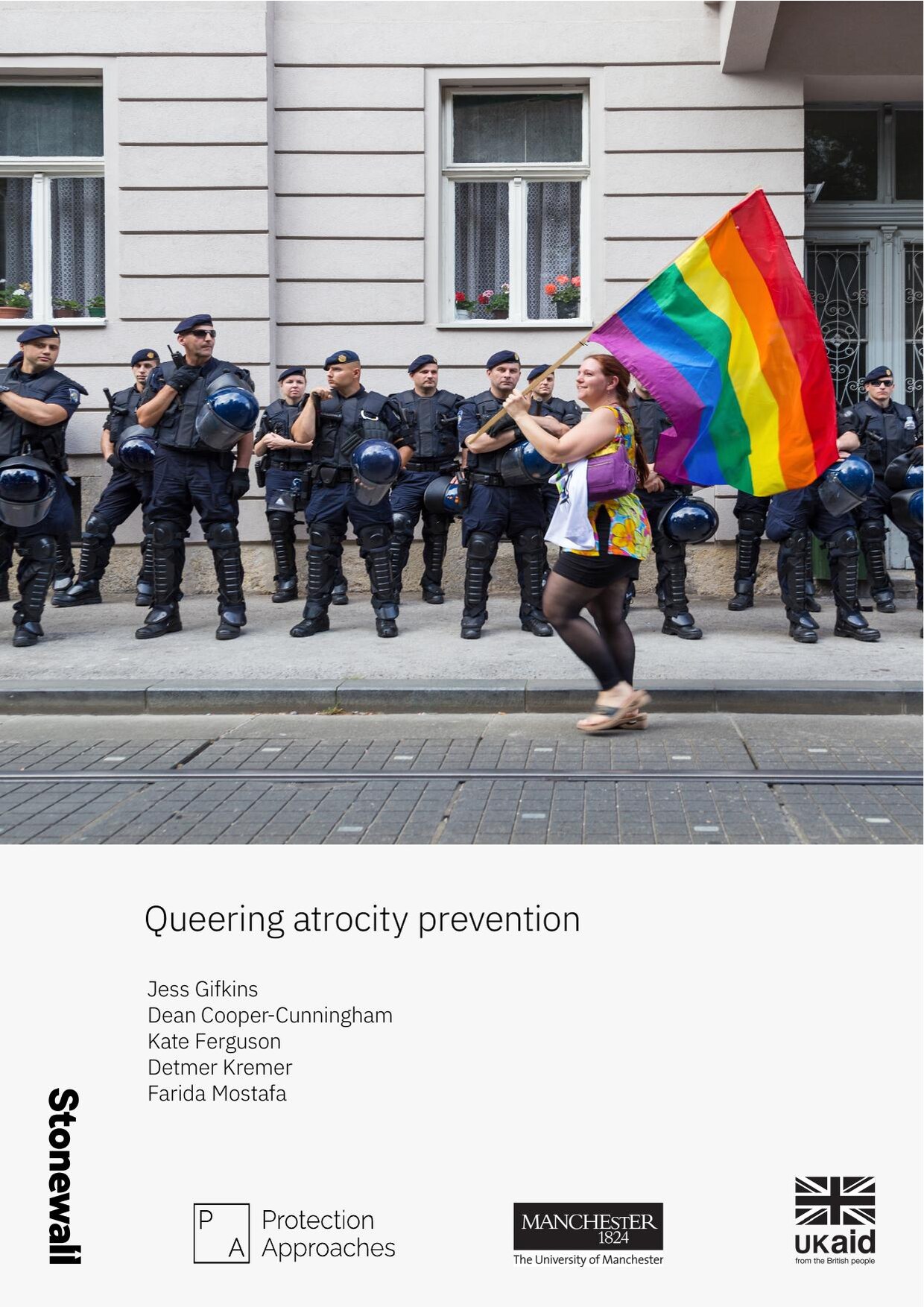 Cover of the report 'Queering atrocity prevention', showing a person carrying a rainbow flag past a line of riot police, with the Stonewall, Protection Approaches, University of Manchester and UK aid logos.