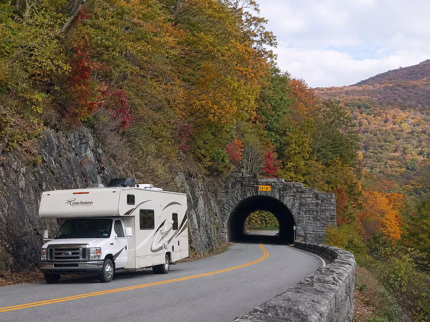 Class C motorhome on a mountain road near Asheville in fall