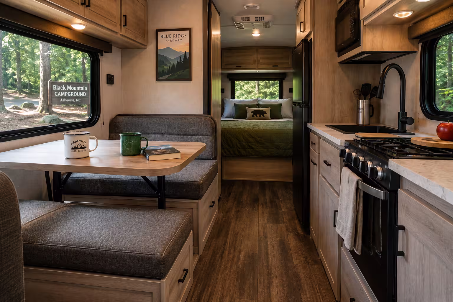 Camper rental interior with kitchen and sleeping area near Asheville