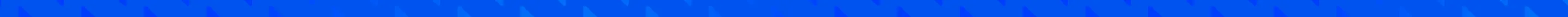 Colorful boat sails on calm blue ocean water under a clear sky.