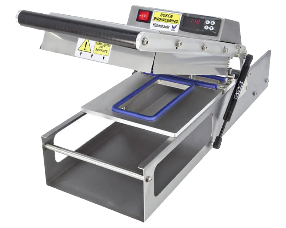 Stainless steel heat sealer machine with digital temperature display and a detachable sealing platform.