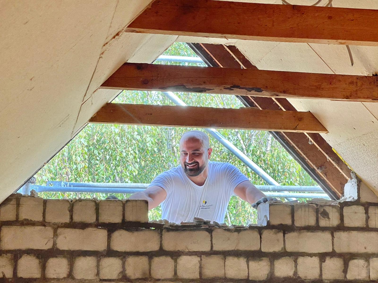 Maurerarbeiten von MFM Bau GmbH an einer Dachschräge mit neu gesetztem Mauerwerk