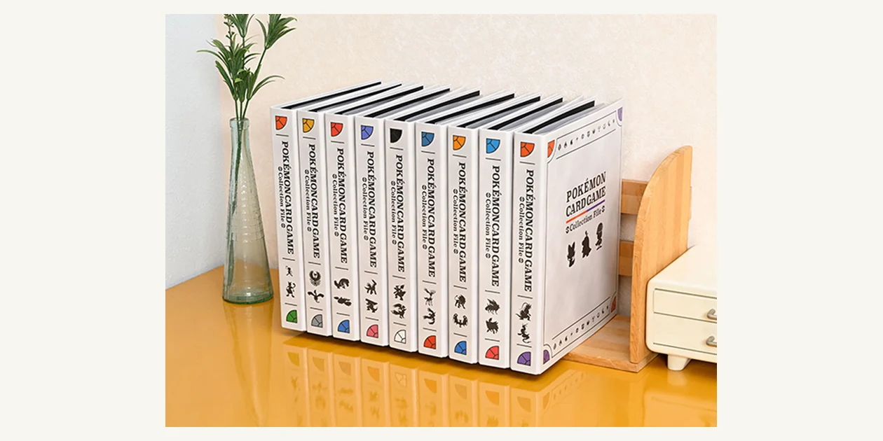 Official photograph of nine Pokémon Collection File Premium binders arranged on a shelf