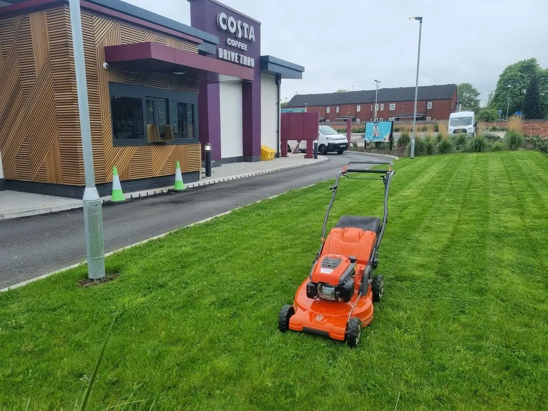 mower cutting grass on business park