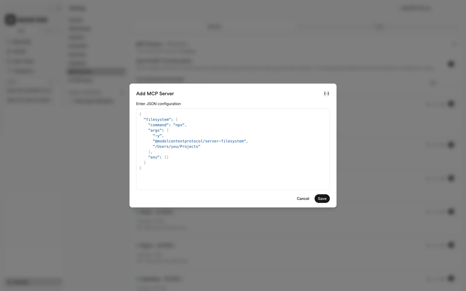 Atomic Chat JSON editor containing the equivalent filesystem MCP server command, arguments, and empty environment object