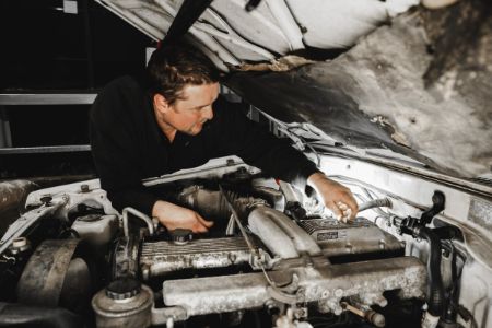 A photo of a mechanic fixing car