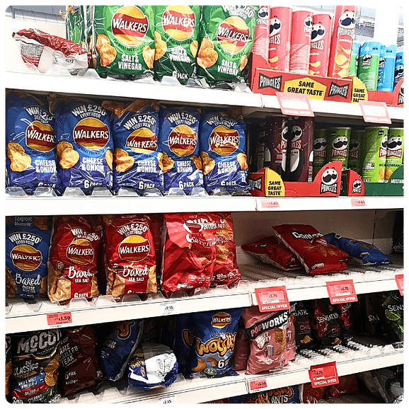 Shelves in a grocery store showcasing 'deformed' products (crisp packets).
