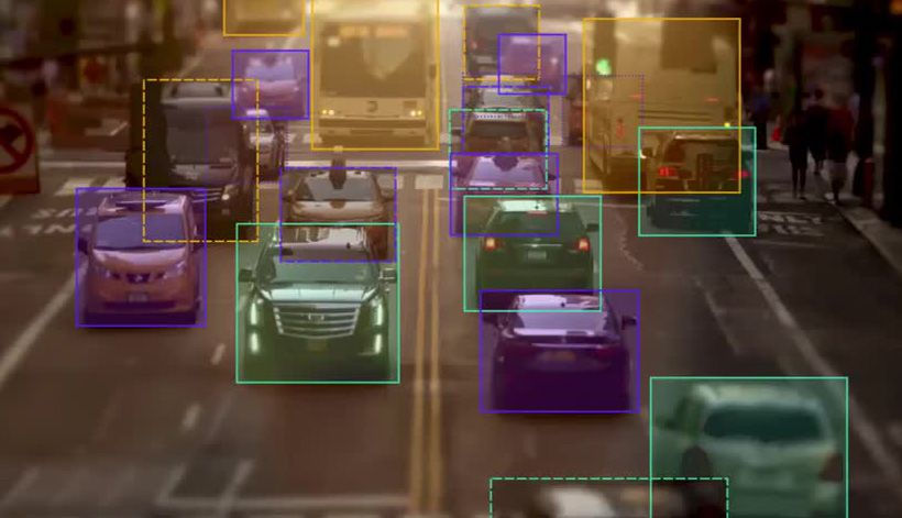 Traffic on a road with bounding boxes around the vehicles.