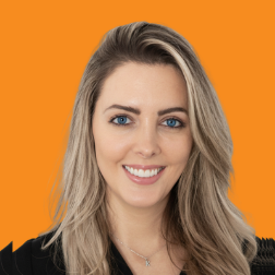 Headshot of a Neurolabs team member with long blonde hair against an orange background