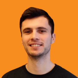 Headshot of a Neurolabs team member with short dark hair in a black top against an orange background