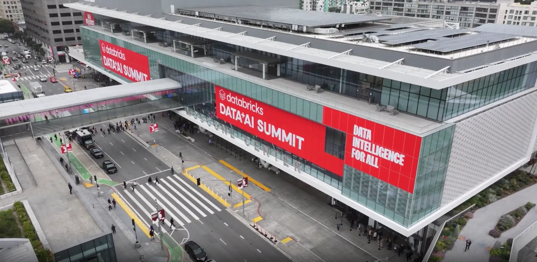 Aerial view of Moscone Center in San Francisco draped in red Databricks Data + AI Summit banners