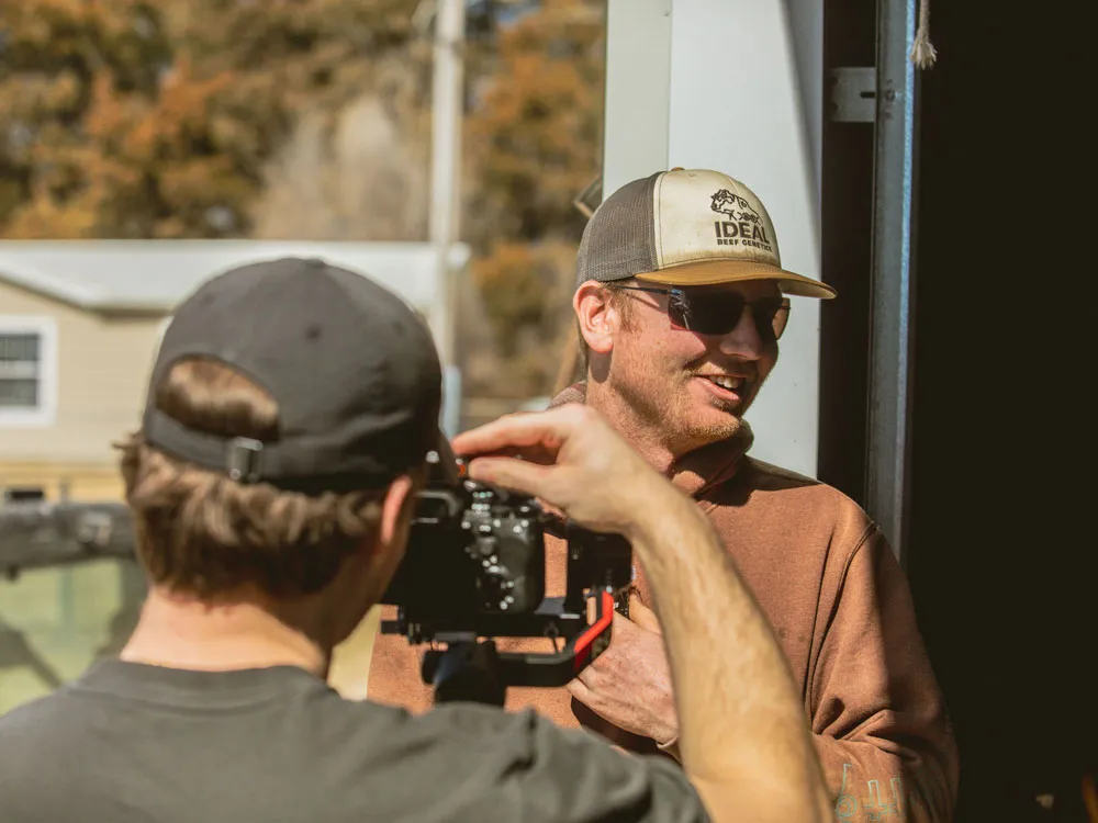 person filming rancher with camera on Nebraska ranch