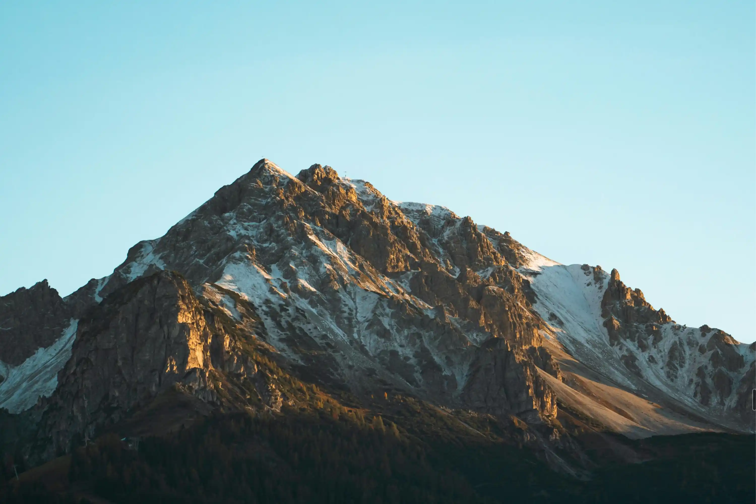 Sunlit rugged mountain peak.