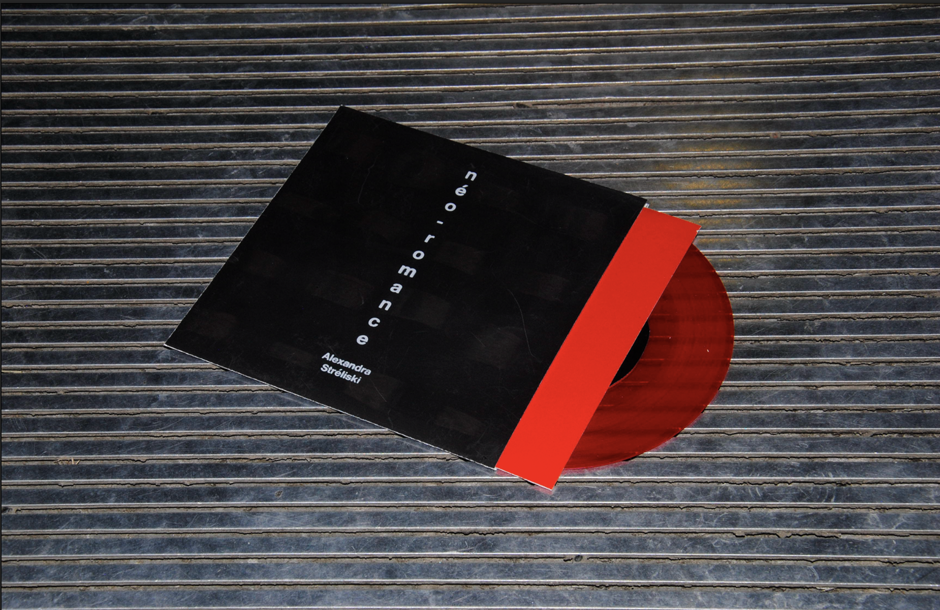 Image of the opened vinyl adaptation on a grey, industrial background.