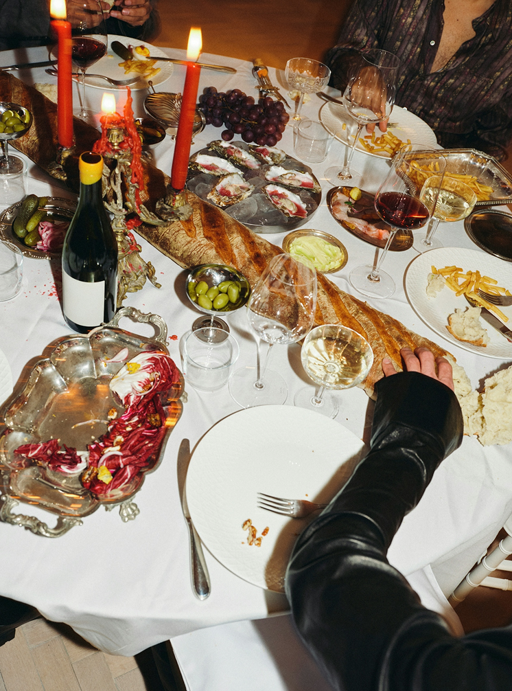 Image set at a party with drinks and seafood.