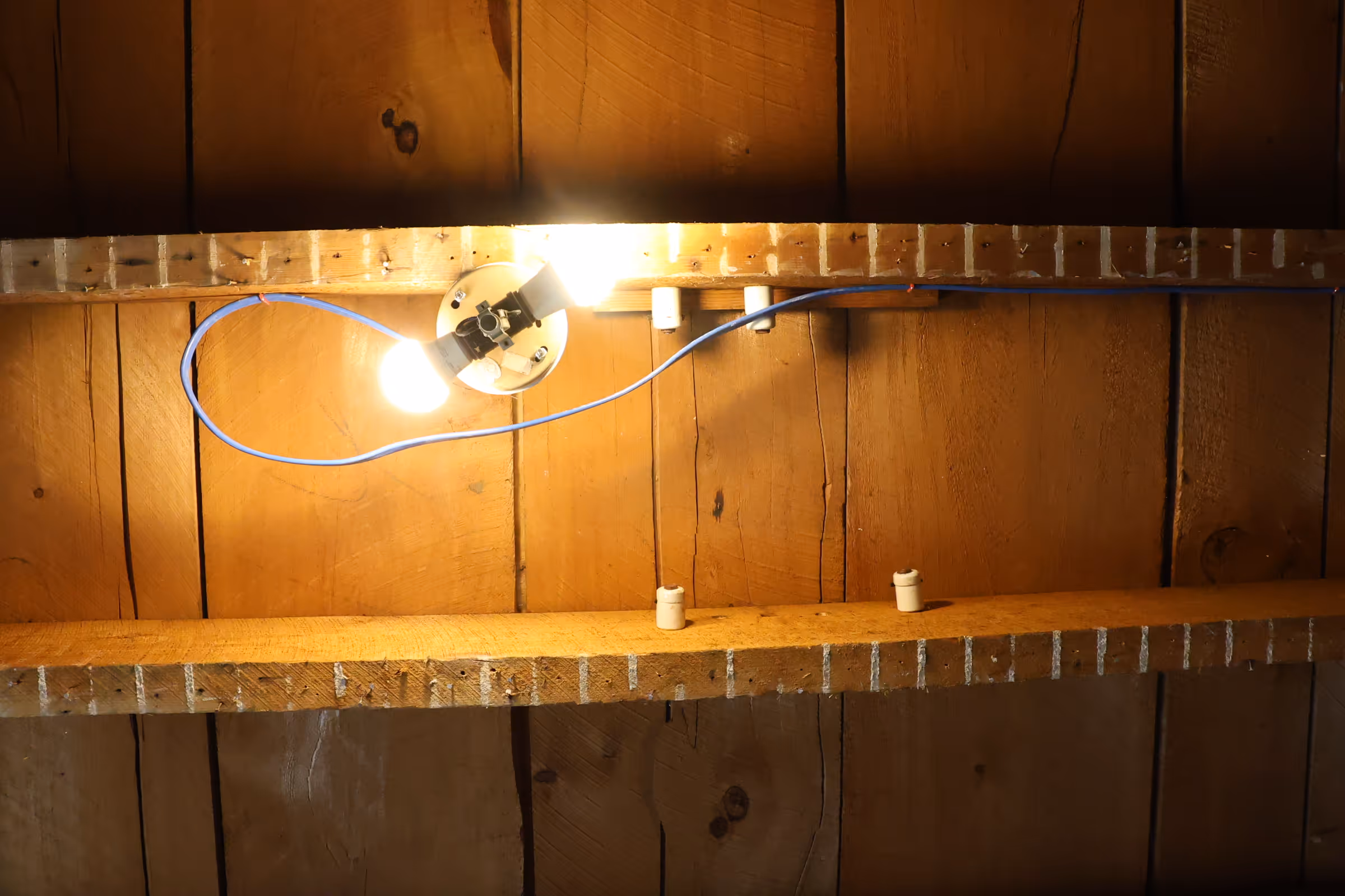 Ceiling with outdated electric knobs and newly installed light fixture