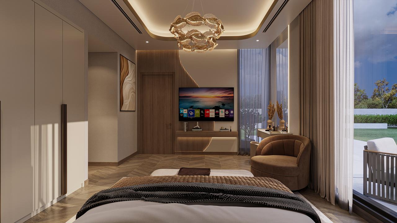 Modern bedroom with a large bed, a round brown chair, a wall-mounted flat-screen TV, wooden accents, and large windows with beige curtains overlooking a patio.
