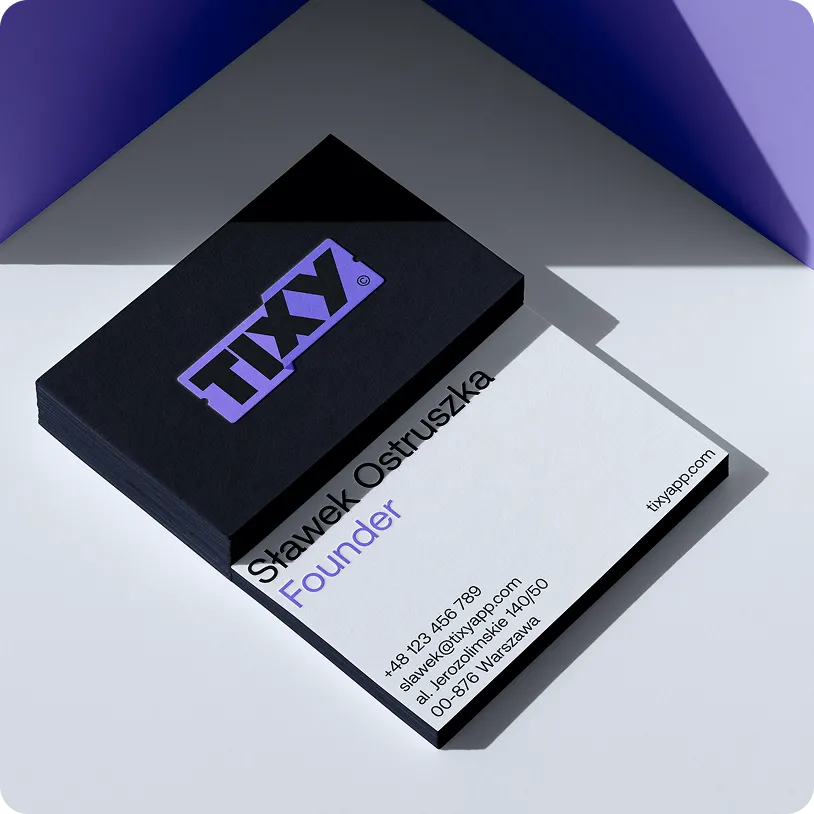 Stack of black business cards with the purple TIXY logo and a white card showing contact details for Stawek Ostruszka, Founder.