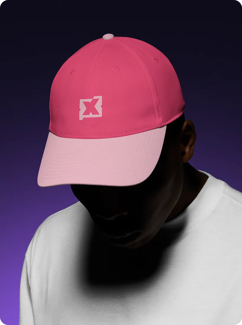 Person wearing a two-tone pink baseball cap and a white shirt against a dark purple background.
