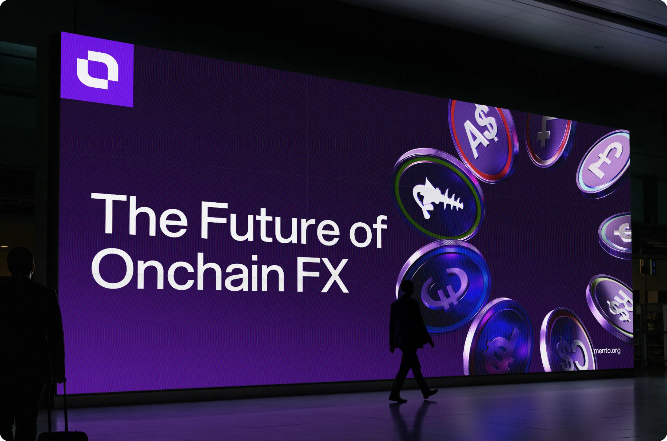 Large digital billboard with text 'The Future of Onchain FX' alongside floating coin icons with various currency symbols.
