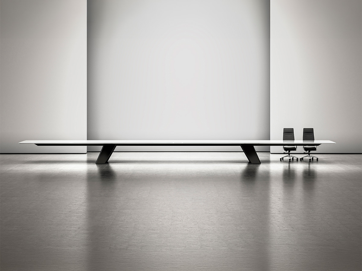 Expanse table in a large studio setting with two chairs.