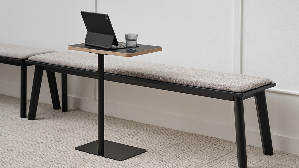 Bench against a wall with laptop table