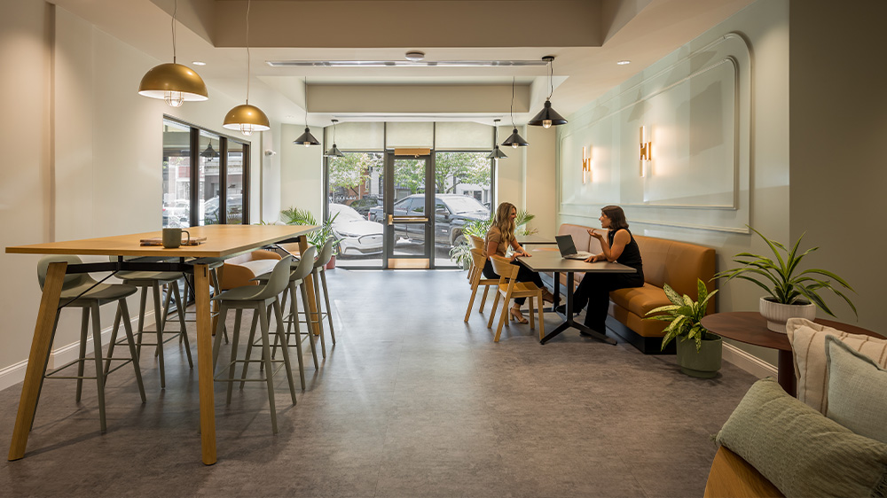 People sitting in a room with multiple tables