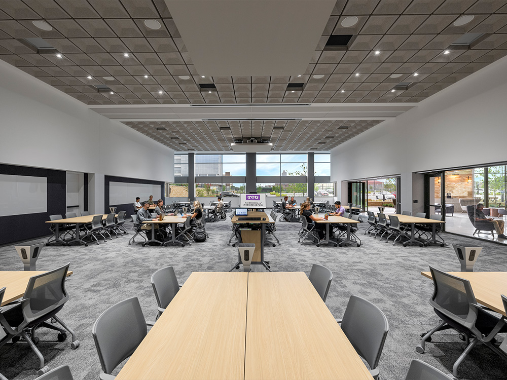 Large room with multiple tables and chairs