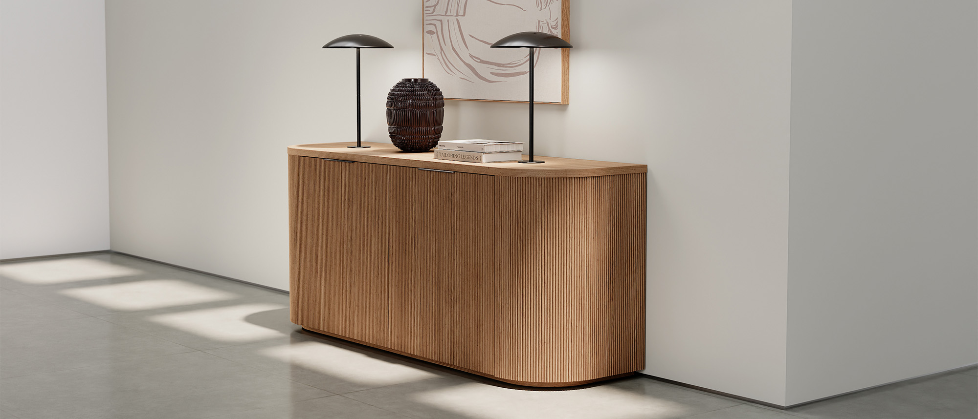 Luna credenza with accent lights against a white wall with artwork. 