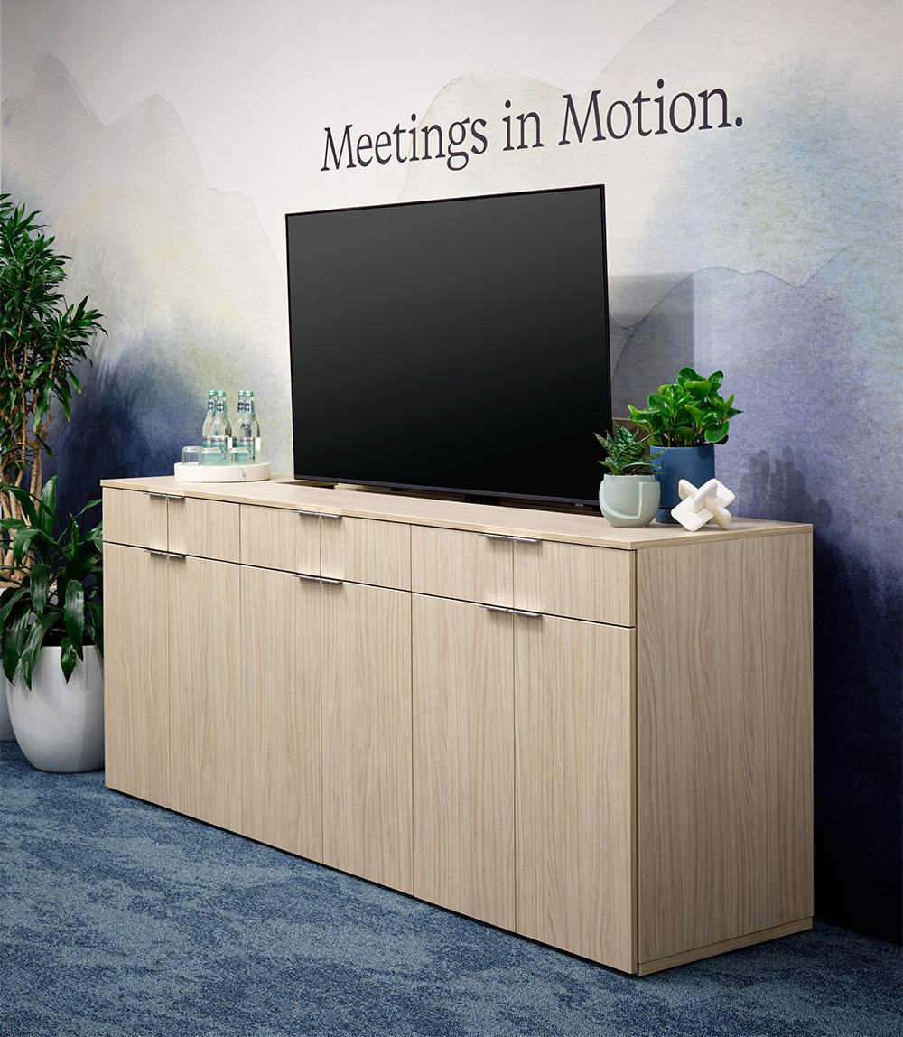 Foundation Monitor Lift credenza with a wall graphic. 
