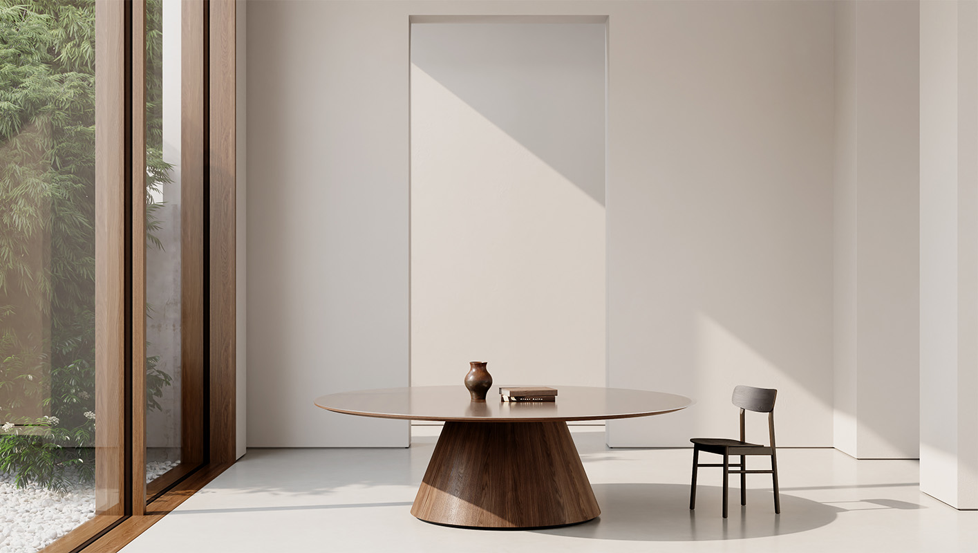 Foundation Tapered Drum table in a room with a chair. 