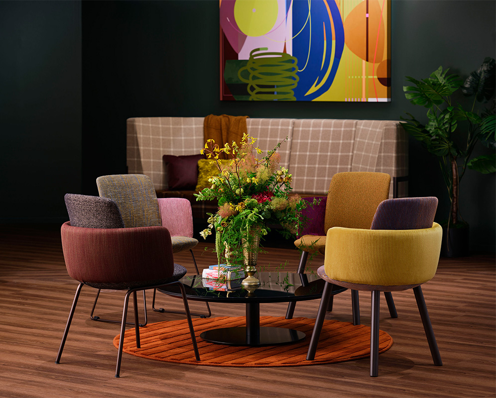 Disc base table with colorful chairs. 