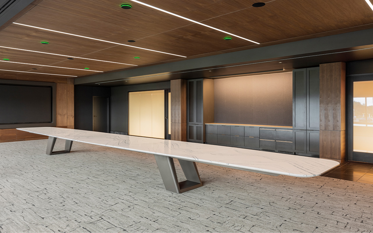 Expanse table in a large conference room. 