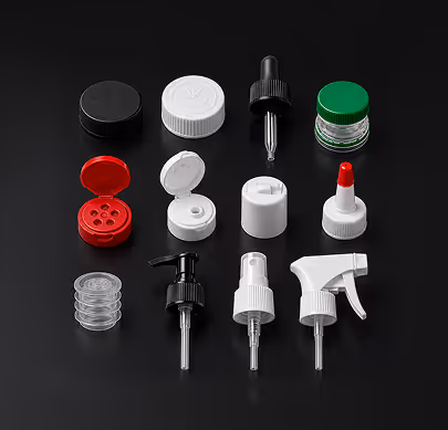 Various black, white, red, and green bottle caps and spray nozzles on black background.