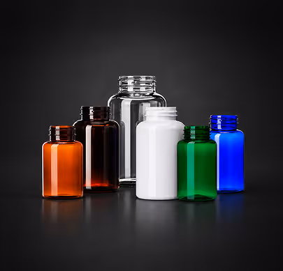 Six empty colored glass bottles in orange, dark brown, clear, white, green, and blue on black background.