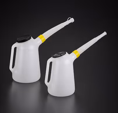 Two white plastic oil cans with black lids and yellow spout connectors on a dark background.