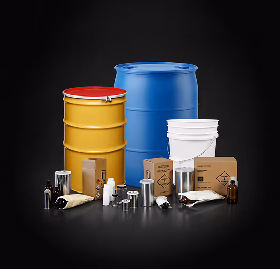 Various industrial containers including blue and yellow barrels, white bucket, metal cans, bottles, and cardboard boxes.