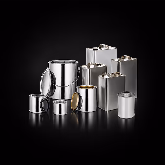 Various sizes of empty shiny metal paint cans and rectangular containers on a black background.