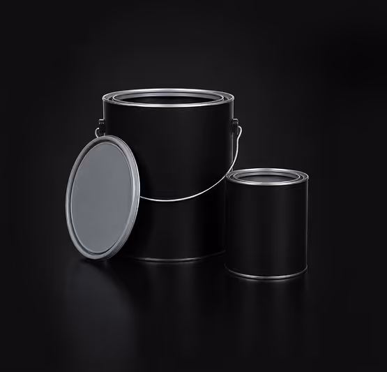 Two black metal paint cans, one large with lid off leaning beside it, on a black background.